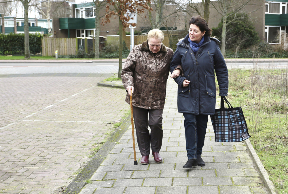 women helping elderly lady